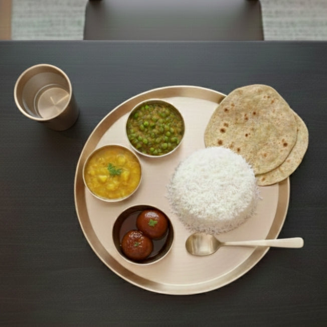 Traditional Indian thali served in brass and bronze ware
